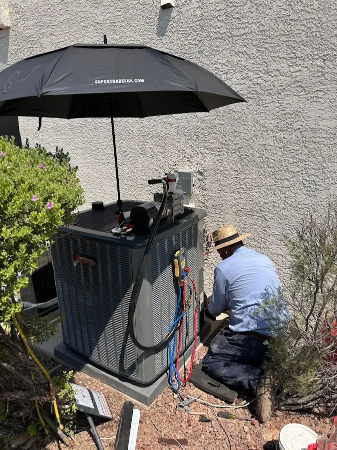 HVAC technician performing outdoor AC maintenance in New Braunfels